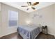 Cozy bedroom with a ceiling fan, natural light, and laminate wood flooring at 1426 Clipperton Ave, Henderson, NV 89074