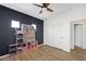 Charming bedroom featuring a dark accent wall, wood-look floors, and playful decor, perfect for a space at 1426 Clipperton Ave, Henderson, NV 89074