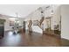 Open-concept dining room with dark wood flooring, a statement chandelier, and staircase at 1426 Clipperton Ave, Henderson, NV 89074