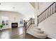 Bright living room features a fireplace, plantation shutters, dark wood flooring, and a staircase at 1426 Clipperton Ave, Henderson, NV 89074