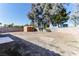 Large backyard featuring a storage shed, mature trees, and block wall fencing at 144 La Mirada Dr, Henderson, NV 89015