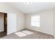 Comfortable carpeted bedroom featuring a window for natural light at 144 La Mirada Dr, Henderson, NV 89015