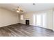 Spacious living room with luxury vinyl plank flooring, fireplace and glass doors leading to backyard at 144 La Mirada Dr, Henderson, NV 89015