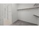 Spacious walk-in closet with built-in shelving and wood floors, adjacent to the bathroom at 1479 Melodic Lark Dr, Las Vegas, NV 89138