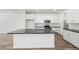 Bright kitchen features white cabinetry, dark countertops and island, and modern appliances at 1479 Melodic Lark Dr, Las Vegas, NV 89138