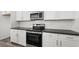 Close-up of kitchen featuring stainless steel appliances, sleek countertops, and white cabinets at 1479 Melodic Lark Dr, Las Vegas, NV 89138