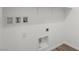 Empty laundry room with white walls, tile flooring, and utility connections at 1479 Melodic Lark Dr, Las Vegas, NV 89138