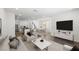 Open-concept living room and dining area featuring modern furnishings and lots of natural light at 1479 Melodic Lark Dr, Las Vegas, NV 89138