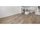 Bright living area with wood-look flooring, leading to a kitchen and staircase at 1479 Melodic Lark Dr, Las Vegas, NV 89138