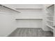 Spacious walk-in closet with ample storage featuring wooden rods and shelving at 1479 Melodic Lark Dr, Las Vegas, NV 89138