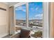 Bedroom view with a comfortable chair near a large window that overlooks the beautiful city skyline at 2000 N Fashion Show Dr # 2021, Las Vegas, NV 89109