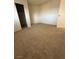 Neutral carpeted bedroom with a view into closet and simple, bright paint at 2080 Karen Ave # 15, Las Vegas, NV 89169