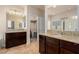 Dual vanity bathroom with granite countertops, dark wood cabinets, and access to a closet at 2149 Morro Vista Dr, Las Vegas, NV 89135