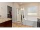 Well-lit bathroom featuring a glass shower, soaking tub, and a view to a walk-in closet at 2149 Morro Vista Dr, Las Vegas, NV 89135