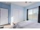 Light blue bedroom with a large window, a double door closet, and ceiling fan at 2149 Morro Vista Dr, Las Vegas, NV 89135