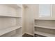 Spacious walk-in closet with carpet, built-in shelves, and a window for natural light at 2149 Morro Vista Dr, Las Vegas, NV 89135