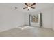 Simple bedroom with tile floors, neutral walls, ceiling fan, and window with curtains at 2201 Tiger Links Dr, Henderson, NV 89012