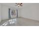 Simple bedroom with tile floors, neutral walls, ceiling fan, and window with curtains at 2201 Tiger Links Dr, Henderson, NV 89012