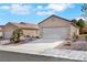 Charming single-story home featuring a two-car garage, desert landscaping, and a paved driveway at 2201 Tiger Links Dr, Henderson, NV 89012