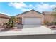 Inviting single-story home featuring desert landscaping, a two-car garage, and modern design elements at 2201 Tiger Links Dr, Henderson, NV 89012