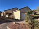 Charming single-story home with desert landscaping, a two-car garage, and a welcoming entryway at 2201 Tiger Links Dr, Henderson, NV 89012