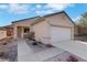 Charming single-story home featuring a two-car garage, low maintenance desert landscaping, and a welcoming front entry at 2201 Tiger Links Dr, Henderson, NV 89012