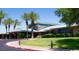 Well-manicured building exterior featuring lush landscaping, palm trees, and a circular driveway at 2201 Tiger Links Dr, Henderson, NV 89012