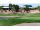 Scenic shot of the golf course and a clubhouse from the golf green, with lush landscaping at 2201 Tiger Links Dr, Henderson, NV 89012