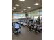 Bright gym with treadmills, elliptical machines, and large windows overlooking the outdoors at 2201 Tiger Links Dr, Henderson, NV 89012