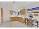 Kitchen with tile flooring, stainless steel appliances, wood cabinets and view to the outside at 2201 Tiger Links Dr, Henderson, NV 89012