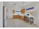 Kitchen with tile flooring, stainless steel appliances, wood cabinets and view to the outside at 2201 Tiger Links Dr, Henderson, NV 89012