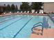 Refreshing swimming pool with lane markers, lifeguard stand, and comfortable lounge chairs for relaxation at 2201 Tiger Links Dr, Henderson, NV 89012