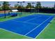 Bright blue tennis court on a sunny day, perfect for a match with friends or Gathering at 2201 Tiger Links Dr, Henderson, NV 89012