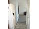 View of a hallway with gray carpet and a white refrigerator on the left at 2240 Highpointe Dr # 201, Laughlin, NV 89029