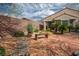 Charming backyard featuring stone pavers, desert landscaping, and a wooden bench at 2629 Chateau Clermont St, Henderson, NV 89044