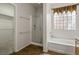 Bathroom with a glass shower enclosure, a soaking tub, and neutral tile floors at 2629 Chateau Clermont St, Henderson, NV 89044