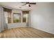 Empty bedroom featuring three windows with blinds, curtains, and light wood flooring at 2629 Chateau Clermont St, Henderson, NV 89044