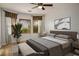 Staged bedroom with neutral colors, large windows, and a ceiling fan at 2629 Chateau Clermont St, Henderson, NV 89044