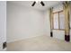 Empty bedroom with a ceiling fan, large window, and carpeted floor at 2629 Chateau Clermont St, Henderson, NV 89044