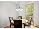 Dining area featuring a round table, four chairs, and sliding glass doors to the exterior at 2629 Chateau Clermont St, Henderson, NV 89044