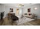 Staged living room featuring wood floors, a modern sofa, and a sliding door at 2629 Chateau Clermont St, Henderson, NV 89044