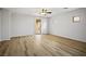 Bright, empty living room boasting wood-look flooring and a sliding glass door to the backyard at 2629 Chateau Clermont St, Henderson, NV 89044