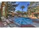 Inviting in-ground hot tub with clear blue water, surrounded by patio and palm trees at 270 E Flamingo Rd # 433, Las Vegas, NV 89169