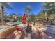 Relaxing outdoor pool area with tables, chairs, and umbrellas for shade on a sunny day at 270 E Flamingo Rd # 433, Las Vegas, NV 89169