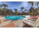 Gorgeous community pool with inviting blue water, surrounded by palm trees and lounge chairs at 270 E Flamingo Rd # 433, Las Vegas, NV 89169