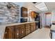 Well-lit kitchen featuring granite countertops, wooden cabinets, and essential appliances providing a practical cooking space at 2967 Pinehurst Dr, Las Vegas, NV 89109