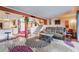 Bright living room with a cozy sofa, unique rug, and staircase offering a comfortable and stylish gathering space at 2967 Pinehurst Dr, Las Vegas, NV 89109