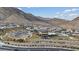 Scenic aerial view of a community center, pool, and houses against a mountain backdrop at 3018 Fall Solstice Ct, Las Vegas, NV 89138