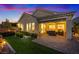 Backyard view with a covered patio, outdoor seating, lush lawn, and a cozy fire pit at 3018 Fall Solstice Ct, Las Vegas, NV 89138