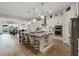 Spacious kitchen with an island, seating, pendant lights, and modern appliances at 3018 Fall Solstice Ct, Las Vegas, NV 89138